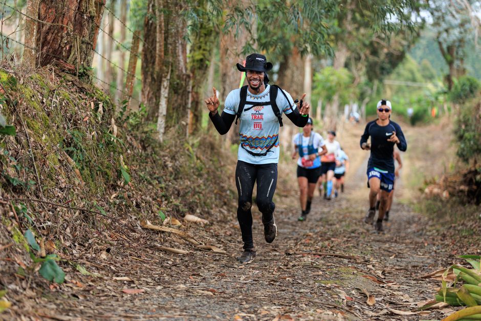 Trail runners racing through a forest path, enjoying the natural setting and camaraderie.